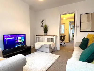 a living room with two couches and a flat screen tv at 2 bedroom house 12mins walk to town in Shrewsbury