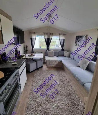 a living room with purple writing on the floor at Snowdon Summit 017 in Barmouth