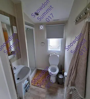 a bathroom with a toilet and a sink at Snowdon Summit 017 in Barmouth