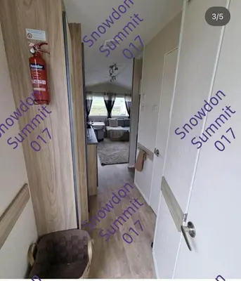 a hallway with purple writing on the floor next to a door at Snowdon Summit 017 in Barmouth