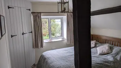 a bedroom with a bunk bed and a window at Welsh Hideaways in Pentre-briwnant