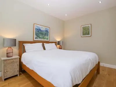 a bedroom with a large white bed and two pictures at The Swan in Hereford