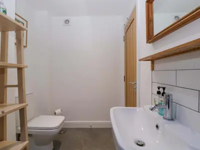 a bathroom with a white sink and a toilet at The Swan in Hereford