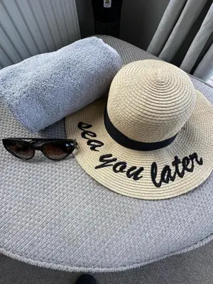 a hat and sunglasses sitting on top of a table at Dolphin View in Llanddwywe