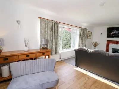 a living room with a couch and a window at Ty Melyn in Aberystwyth