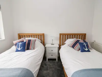 two beds sitting next to each other in a bedroom at Ty Melyn in Aberystwyth