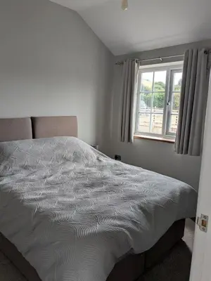 a white bed in a bedroom with a window at Tanyfford Lodge, Abermule, Mid Wales, SY15 6NT in Abermule