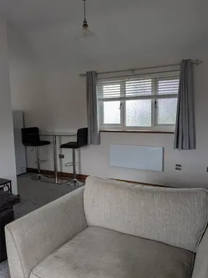a living room with a couch and a window at Tanyfford Lodge, Abermule, Mid Wales, SY15 6NT in Abermule