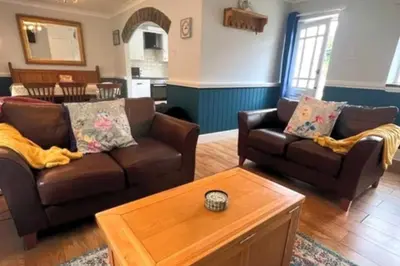 a living room with two couches and a coffee table at 3 Bed Harbour-view Cottage Sleeps 6 - Dog Friendly in New Quay