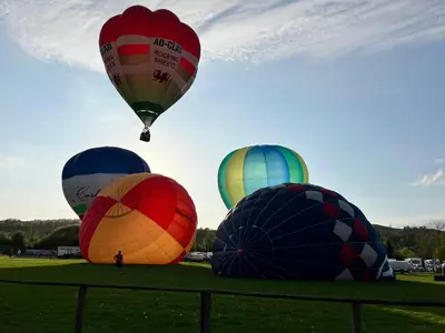 a group of hot air balloons in a field at Oakies Farm Stays XL in Llandovery