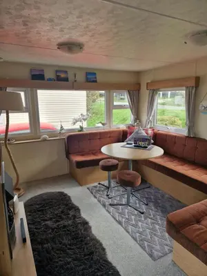 a living room with a couch and a table at Brynowen Holiday Park Borth in Borth
