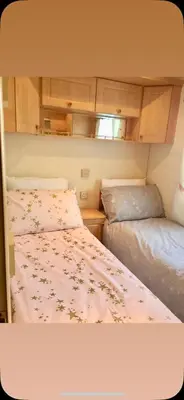 a bedroom with two beds in a trailer at Family 3 Bedroom Caravan at Clarach Bay in Aberystwyth