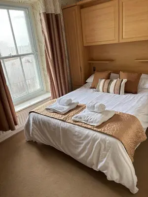 a bedroom with a bed with two towels on it at Hazeldene Guest House in Aberaeron