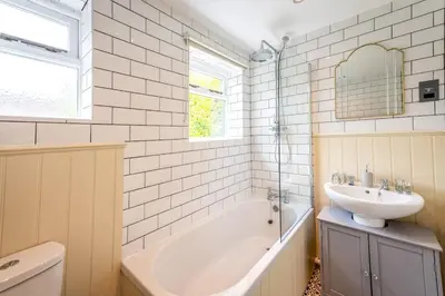 a bathroom with a sink and a bath tub and a sink at Quaint home with log burner in peaceful cul-de-sac in Shrewsbury