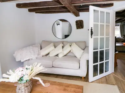 a living room with a couch and a mirror at The Old Shop in Builth Wells