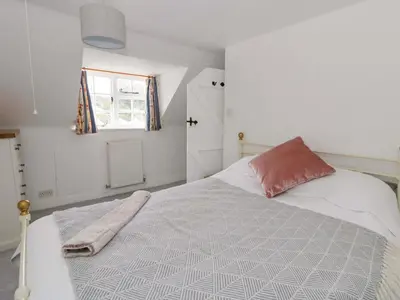 a bedroom with a bed with a blanket on it at The Old Shop in Builth Wells