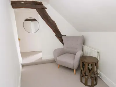 a living room with a chair and a table at The Old Shop in Builth Wells