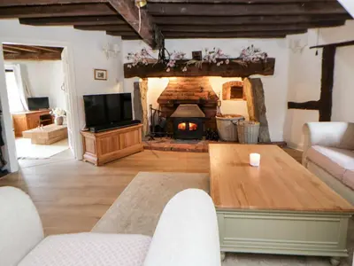 a living room with a table and a fireplace at The Old Shop in Builth Wells