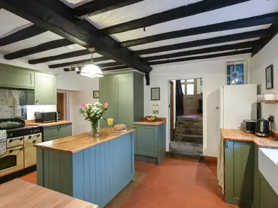 a kitchen with green cabinets and a white refrigerator at Manor Farmhouse in Church Stretton