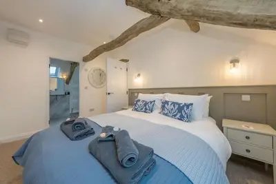 a bedroom with a large bed with towels on it at Melin-Bennar in Dyffryn