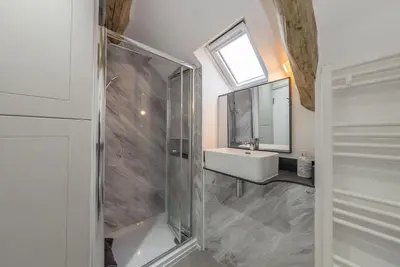 a bathroom with a sink and a glass shower at Melin-Bennar in Dyffryn