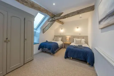a bedroom with two beds and a window at Melin-Bennar in Dyffryn