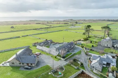 an aerial view of an old house in a field at Melin-Bennar in Dyffryn