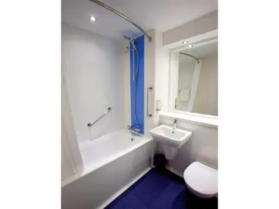 a bathroom with a tub and a sink and a toilet at Travelodge Ludlow in Ludlow