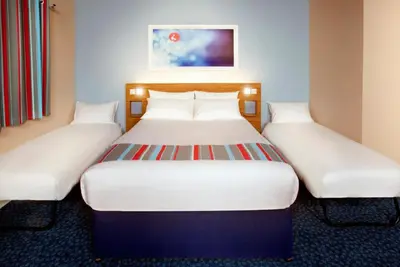 a pair of beds in a hotel room at Travelodge Ludlow Woofferton in Brimfield