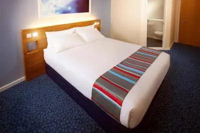 a bedroom with a large bed in a hotel room at Travelodge Ludlow Woofferton in Brimfield