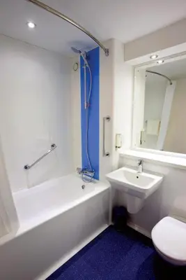 a bathroom with a sink and a tub and a toilet at Travelodge Oswestry in Oswestry