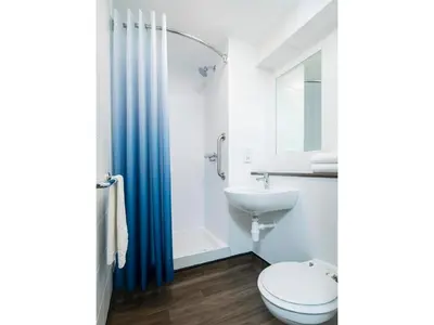 a bathroom with a toilet and a sink at Travelodge Oswestry in Oswestry