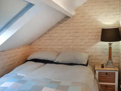 a bedroom with a bed and a brick wall at Brig Y Don in Borth