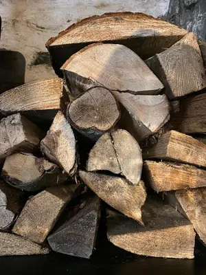 a pile of logs sitting on top of each other at Pont Wrysgen Cottage 'the gateway to Snowdonia' in Mallwyd