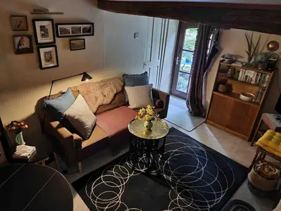 a living room with a couch and a table at Pont Wrysgen Cottage 'the gateway to Snowdonia' in Mallwyd
