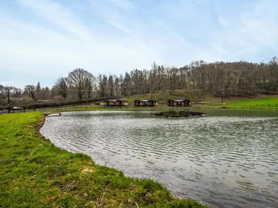 a lake with a group of houses in the background at Lakeside Lodge - Uk50627 in Welshpool