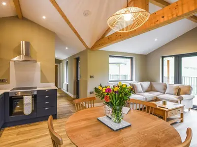 a living room with a table and a couch at Lakeside Lodge - Uk50627 in Welshpool