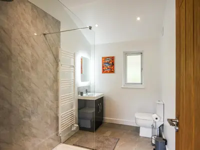 a bathroom with a shower and a toilet and a sink at Lakeside Lodge - Uk50627 in Welshpool