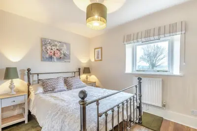 a bedroom with a bed and a window at 3 Bed in Lyonshall oc-h34806 in Lyonshall