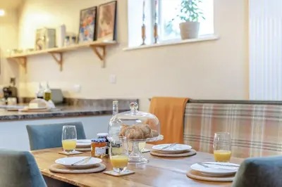 a table with a bottle of wine and a turkey on it at 3 Bed in Lyonshall oc-h34806 in Lyonshall