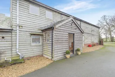 a wooden building with a door on the side of it at 3 Bed in Lyonshall oc-h34806 in Lyonshall
