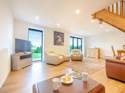 a living room with a couch and a tv at Arenig View - Uk51068 in Frongoch