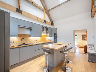 a kitchen with blue cabinets and a wooden counter top at Arenig View - Uk51068 in Frongoch