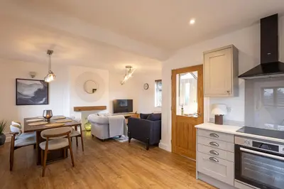 a kitchen and living room with a table and a dining room at Judith House in Shrewsbury