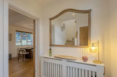 a mirror on a wall above a counter in a room at Judith House in Shrewsbury