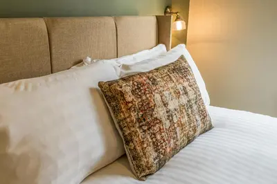 a white bed with a pillow on top of it at Fantastic 6-bedroom house close to Shrewsbury town - Pass the Keys in Shrewsbury
