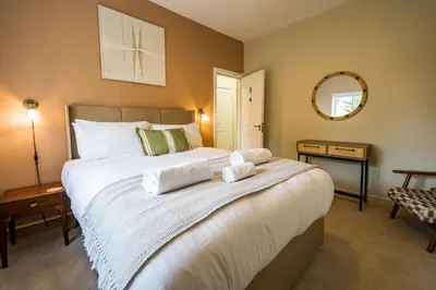 a bedroom with a large bed with towels on it at Fantastic 6-bedroom house close to Shrewsbury town - Pass the Keys in Shrewsbury