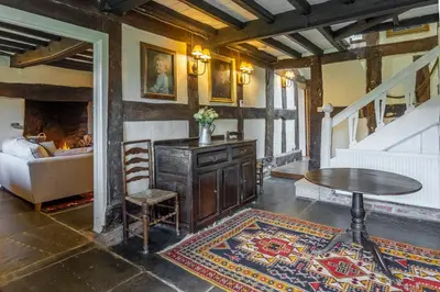 a living room with a table and a couch and a table at Tanat Valley Farmhouse in Hirnant