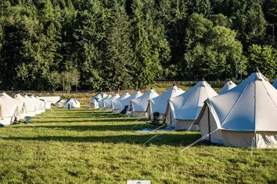 a row of tents sitting in a field at Baskerville Hall Hotel in Clyro