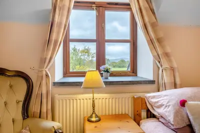 a bedroom with a bed and a window at 3 Bed in Dolgellau oc-24459 in Bont Newydd